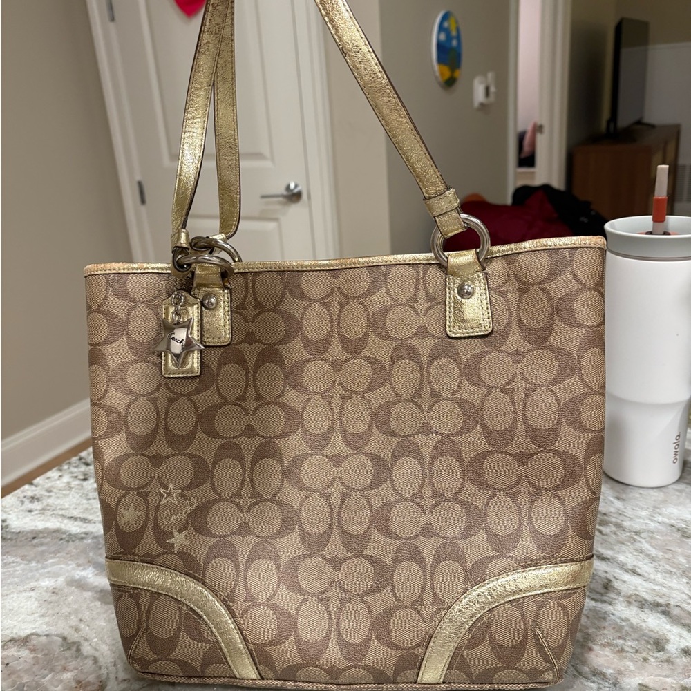 Coach Heritage Signature Star Tote bag in brown and gold with PVC material